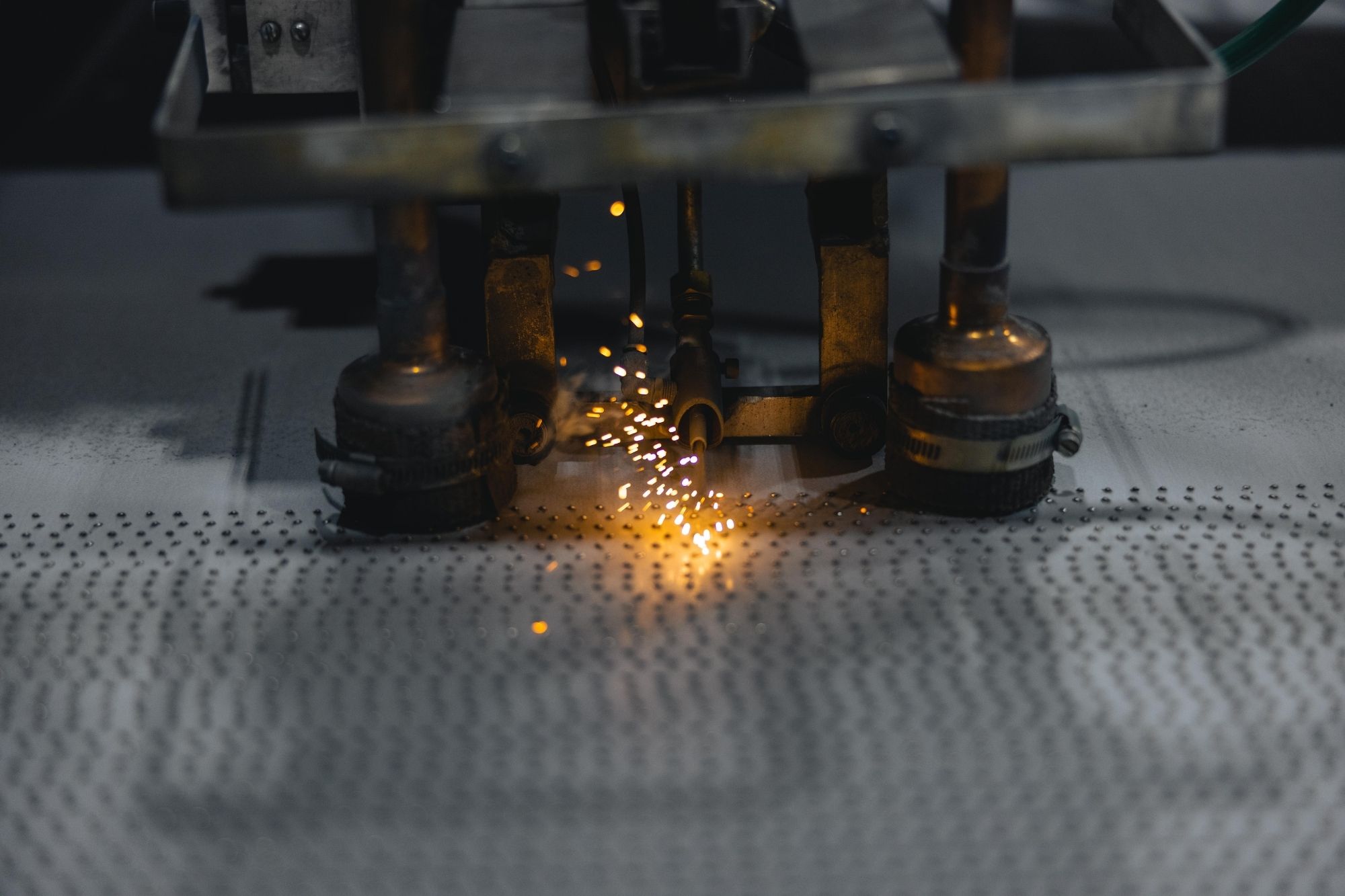 Machine welds traction features to base metal to create AlGrip traction safety flooring