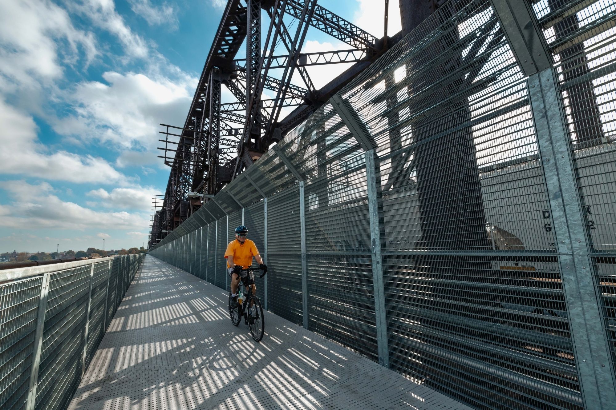 Man rides his bike on Big River Crossing pedestrian bridge in Memphis, TN
